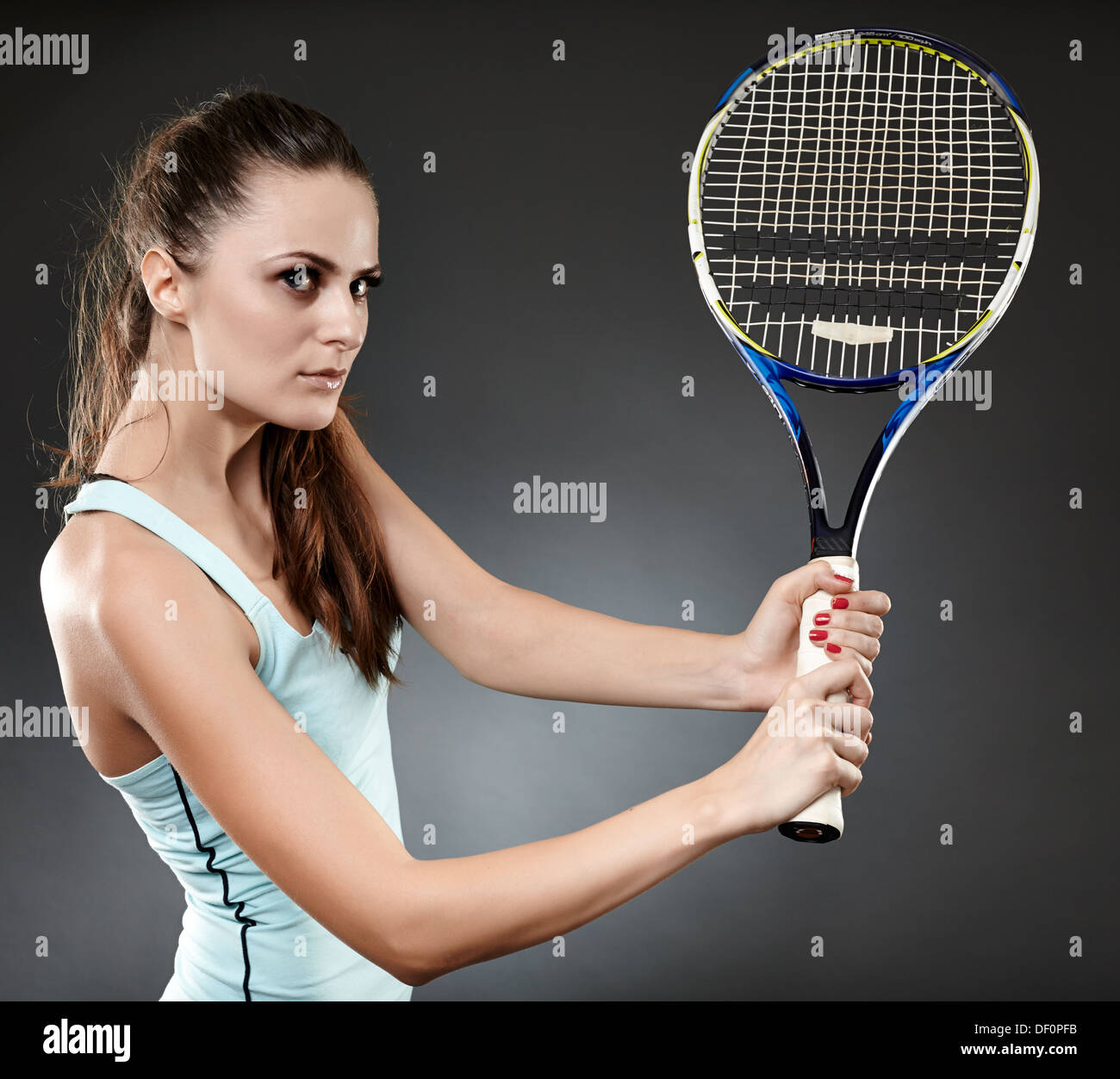 Studio shot of a young woman executing a backhand volley Stock Photo