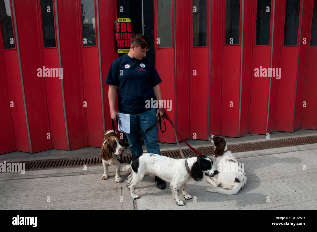 Firefighters strike from 12-4pm in a protest at threats to their pensions. Sophie, firefighter, on the picket line with her dogs Stock Photo