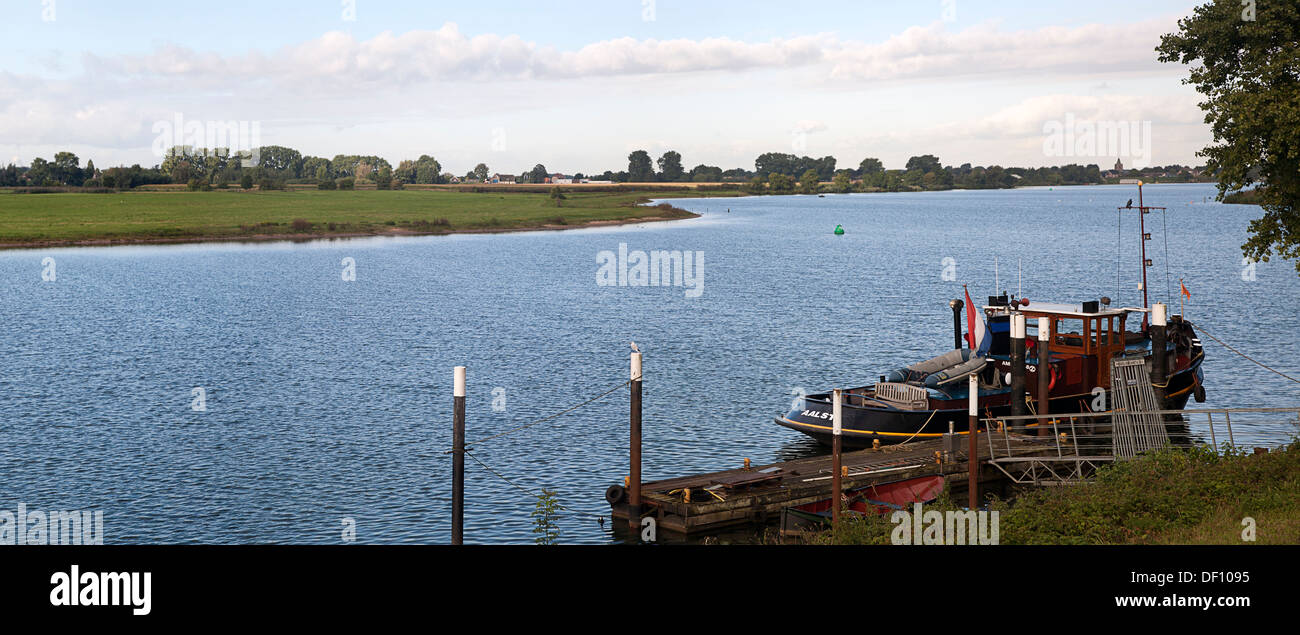 Moored tugboat on river Meuse near Nederhemert, Gelderland, Netherlands Stock Photo