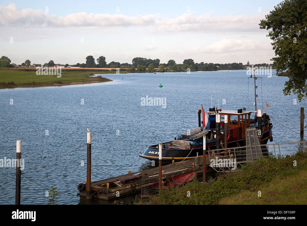 Moored tugboat on river Meuse near Nederhemert, Gelderland, Netherlands Stock Photo
