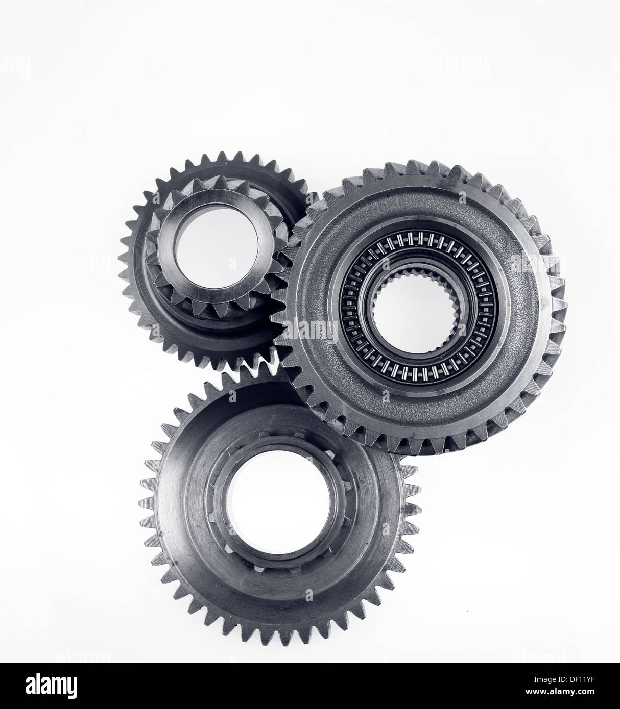 Three metal gears on plain background Stock Photo