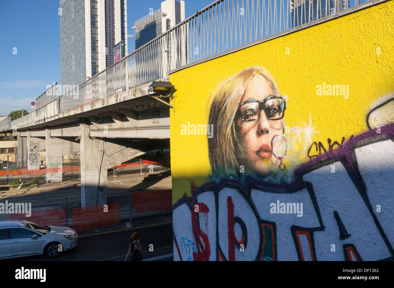 Woman's head on a yellow wall, hand rail and blue sky Stock Photo