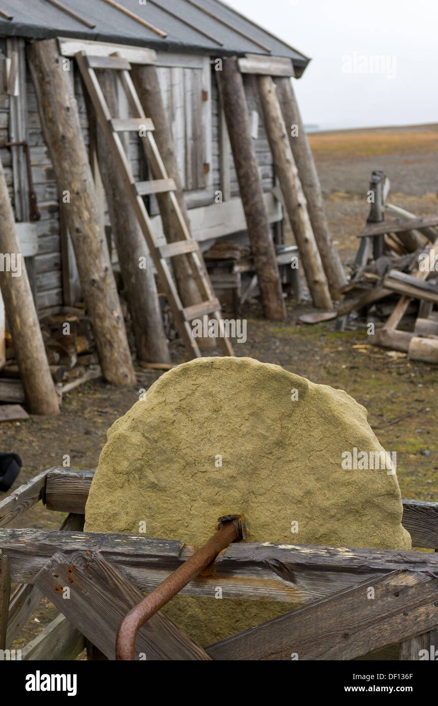 Old grindstone wheel in front of a deserted trapper's hut, Kapp Toscana,  Bellsund, Spitsbergen, Svalbard Archipelago, Norway Stock Photo - Alamy