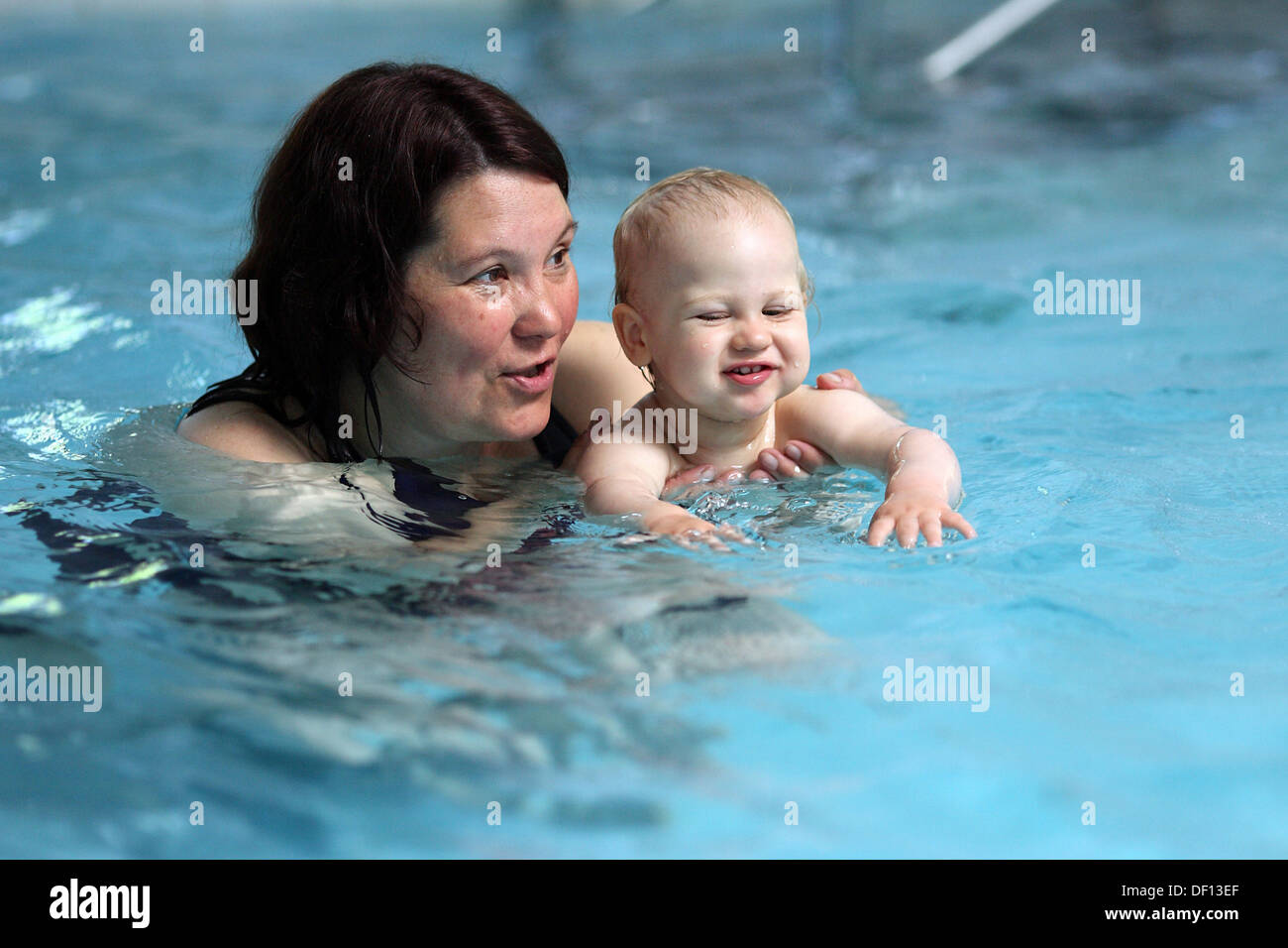 Berlin, Germany, woman with child in baby swimming Stock Photo