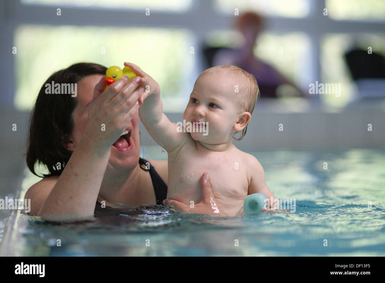 Berlin, Germany, woman with child in baby swimming Stock Photo