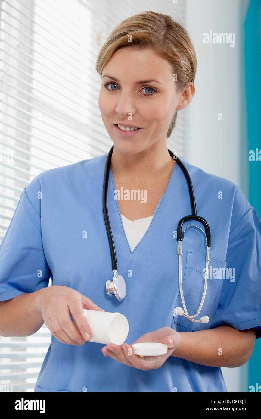 Female Nurse dispensing medicine Stock Photo Alamy