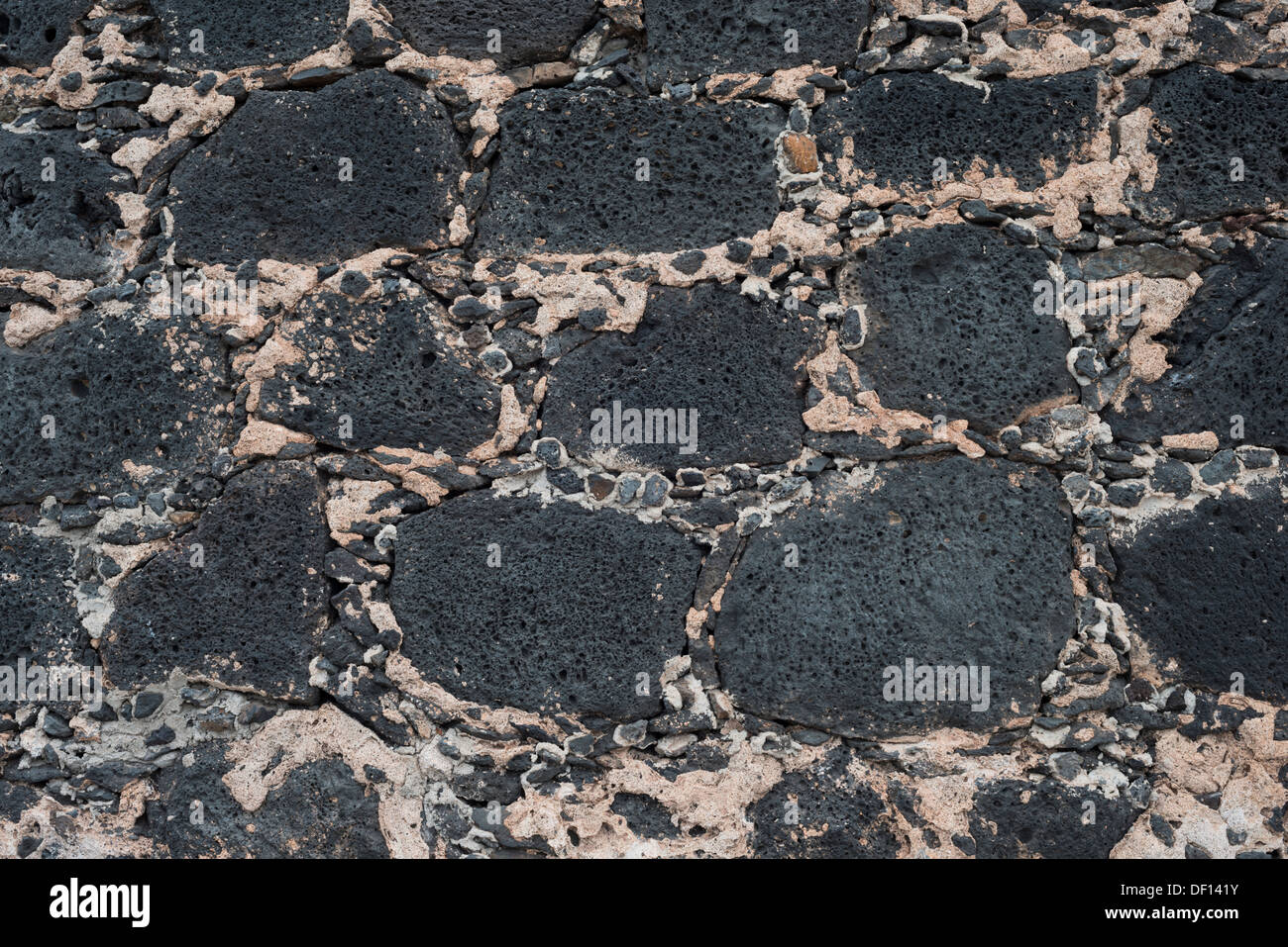 Detail of the wall of Castillo de las Coloradas, Playa Blanca, constructed of vesicular lava blocks and small pebbles in cement Stock Photo