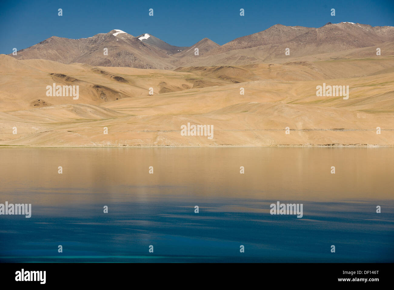 Reflections of hills surrounding the high altitude Lake Tsomoriri, (Ladakh) Jammu & Kashmir