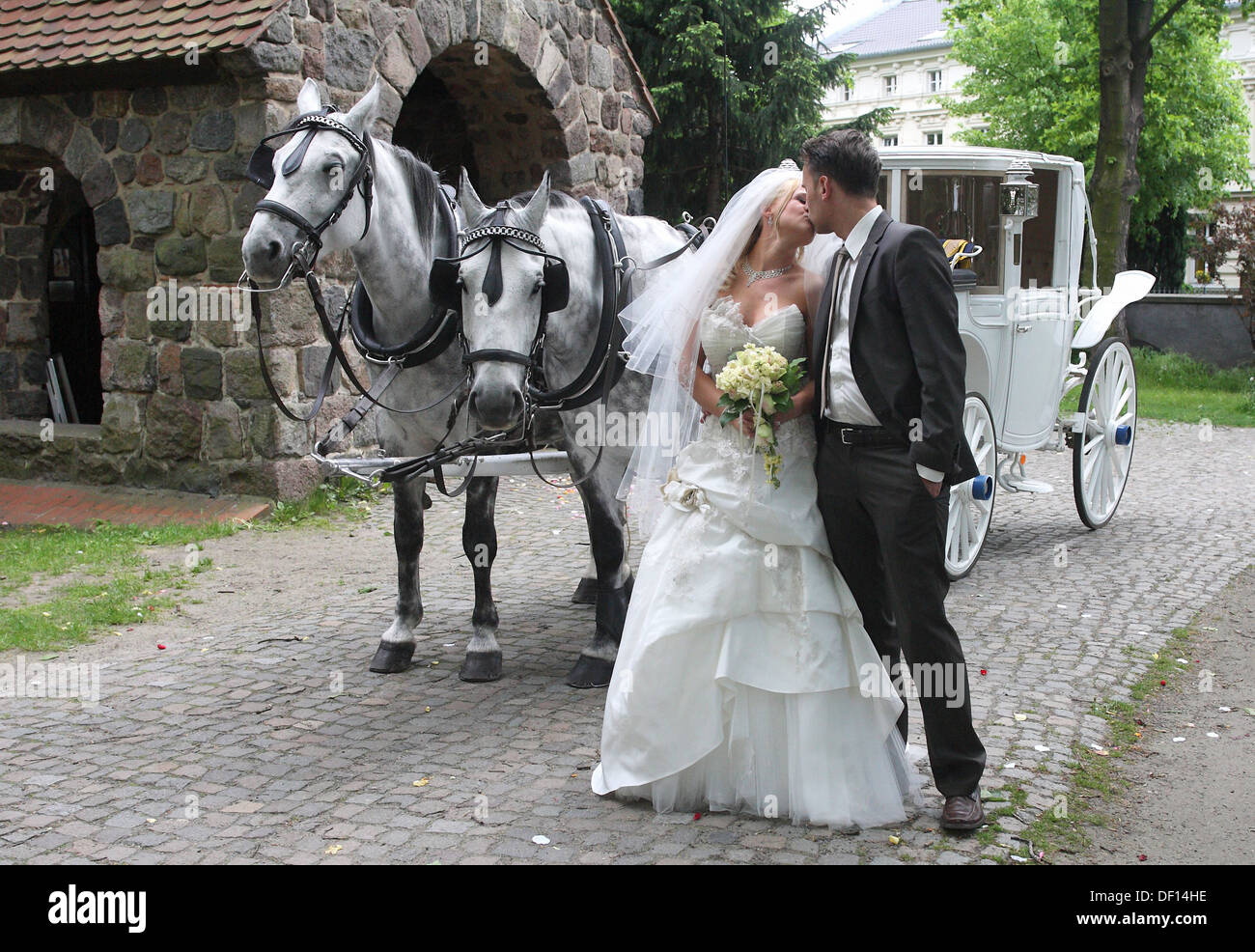 Berlin, Germany, a young married couple with a carriage in front of a church Stock Photo