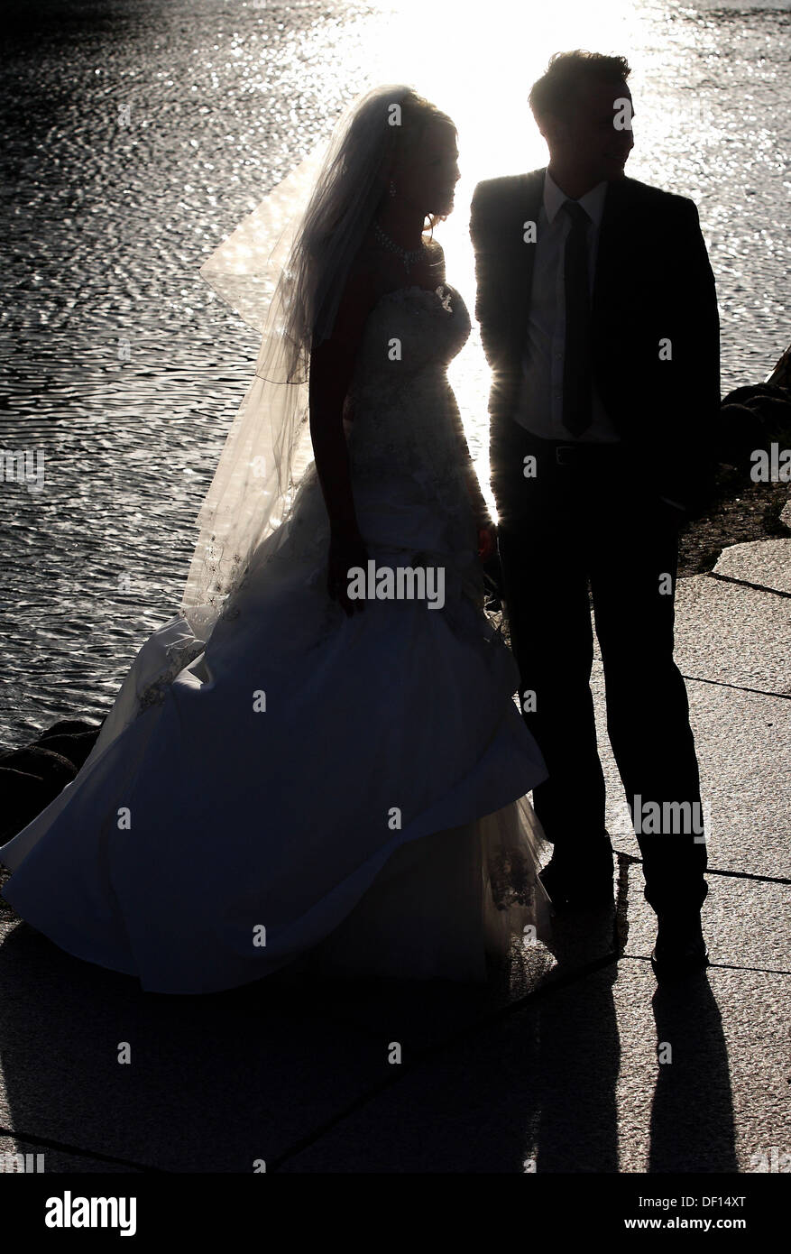 Berlin, Germany, silhouette of a bride and groom on a lake Stock Photo