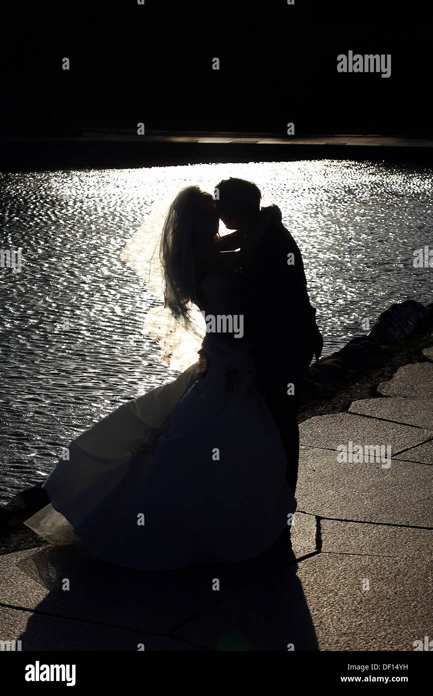 Berlin, Germany, silhouette of a bride and groom on a lake Stock Photo