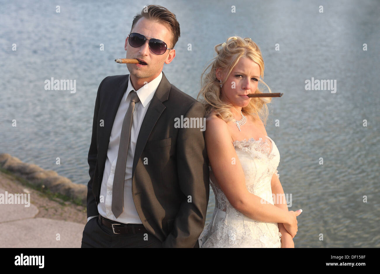 Berlin, Germany, a bride and groom posing with cigar as Mafiapaerchen Stock Photo