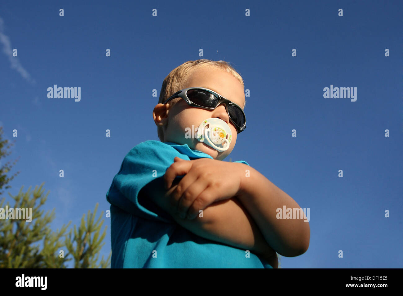 Birkach, Germany, posiet toddler with pacifier and sunglasses Stock Photo