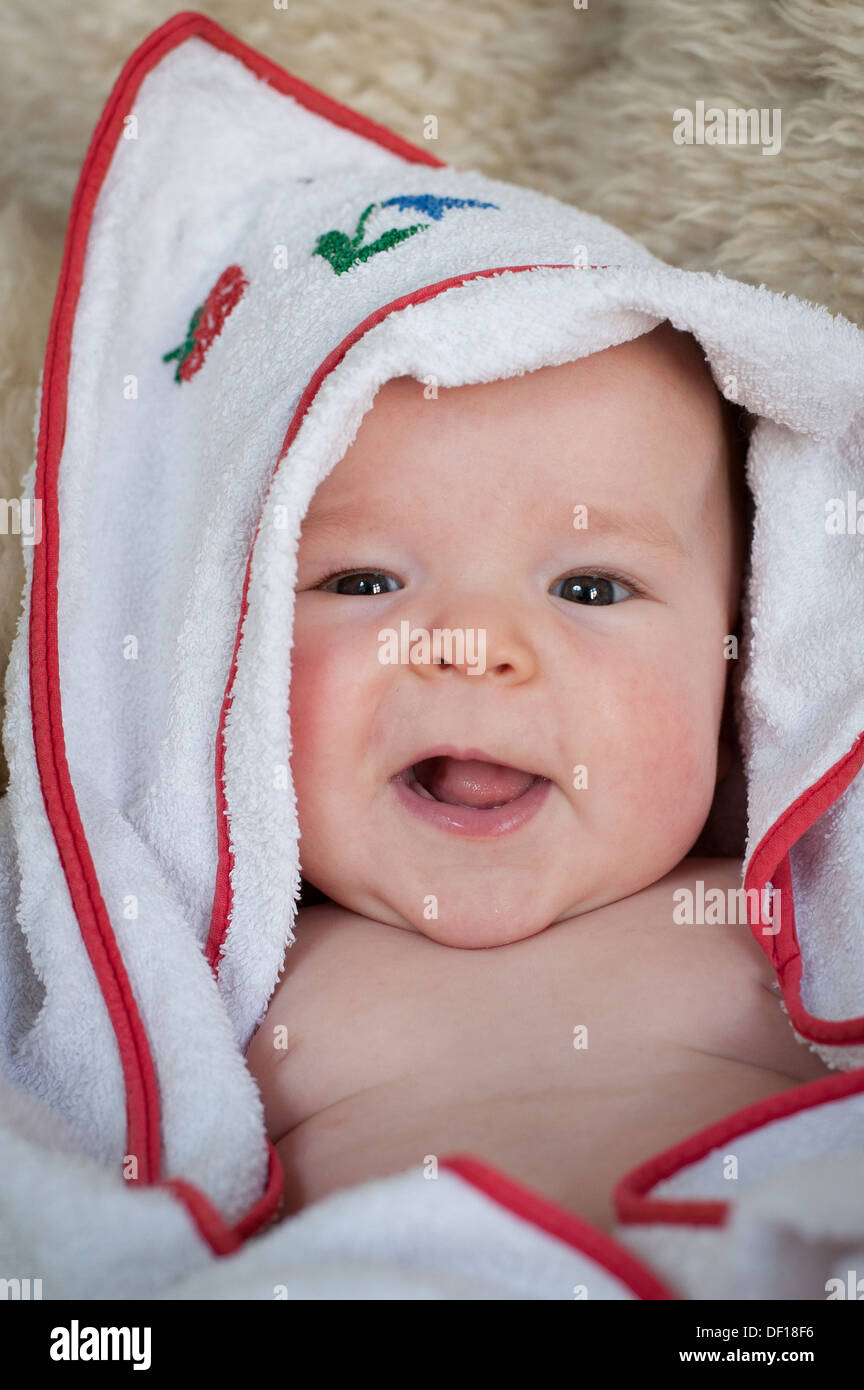 Berlin, Germany, a five month old baby wrapped in a blanket Stock Photo