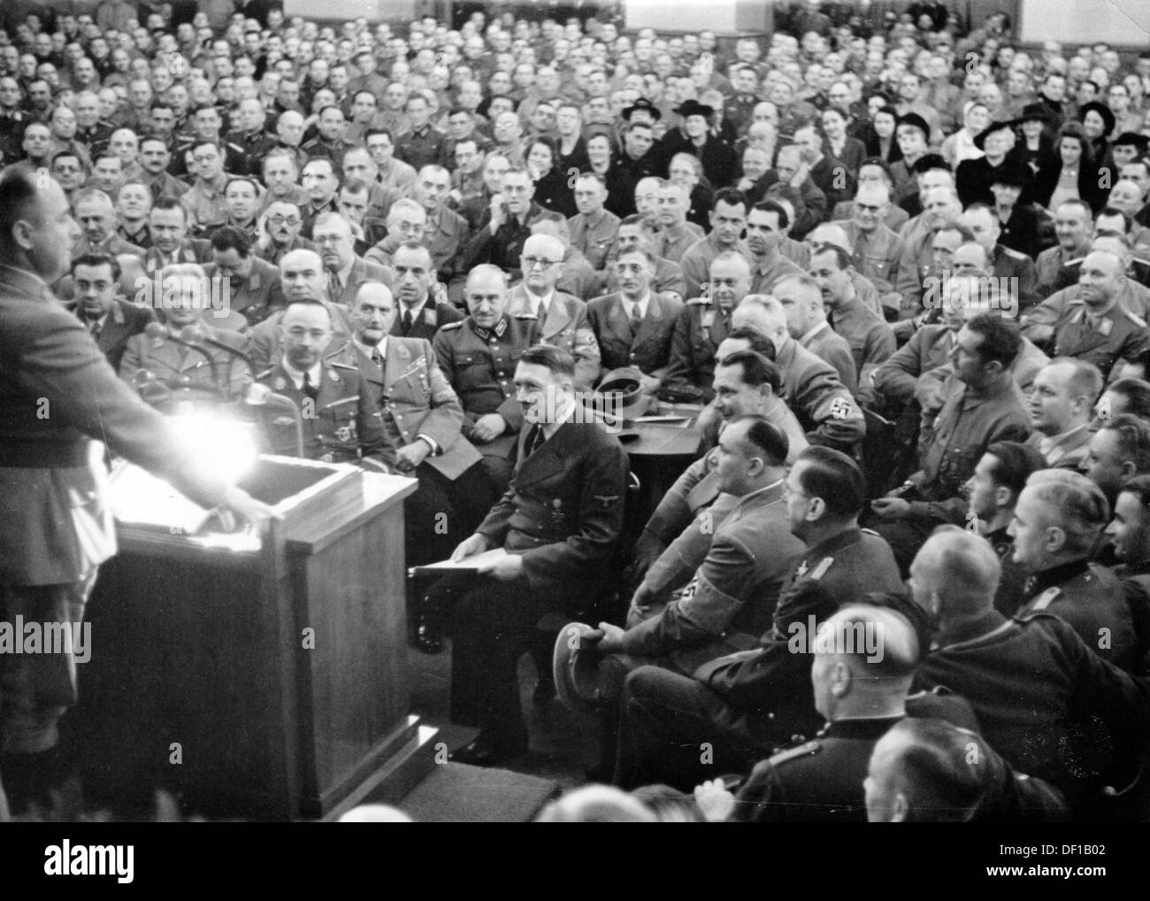 The image from the Nazi Propaganda! shows Adolf Hitler among his 'old comrades' during an hour of commemoration on the occasion of the anniversary of the Beer Hall Putsch of 9 November 1923 in Löwenbräukeller in Munich, Germany, on 9 November 1934(?). Personalities: at the speaker's desk Gauleiter Paul Giesler. To Hitler's right: Hermann Göring, behind him (at the table, partially covered): Joseph Goebbels, Robert Ley, Max Amann, Hermann Esser. Behind the table (r-l): Wilhelm Schepman, Karl Fiehler, Franz Xaver Schwarz. In Front of Schwarz, Konstantin Hierl, to the left Franz Ritter von Epp an Stock Photo