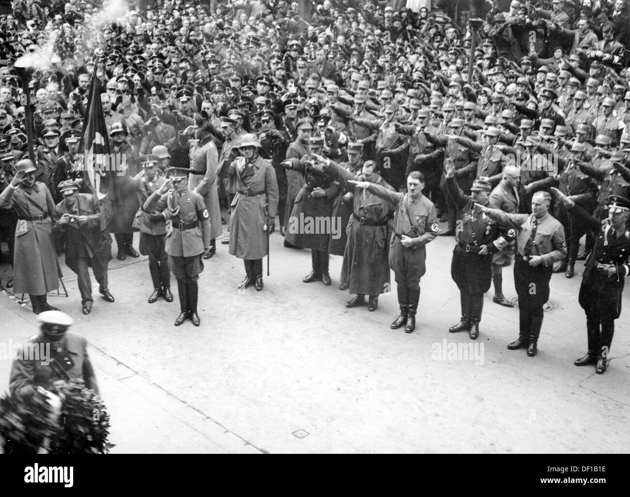 The image from the Nazi Propaganda! shows Adolf Hitler among his supporters during the consecration of the Memorial for the victims of the Beer Hall Putsch of 9 November 1923 on the Feldherrenhalle in Munich, Germany, on 9 November 1933. To Hitler's left: Hermann Göring. To the very right, Reichsführer SS Heinrich HImmler. Fotoarchiv für Zeitgeschichte Stock Photo