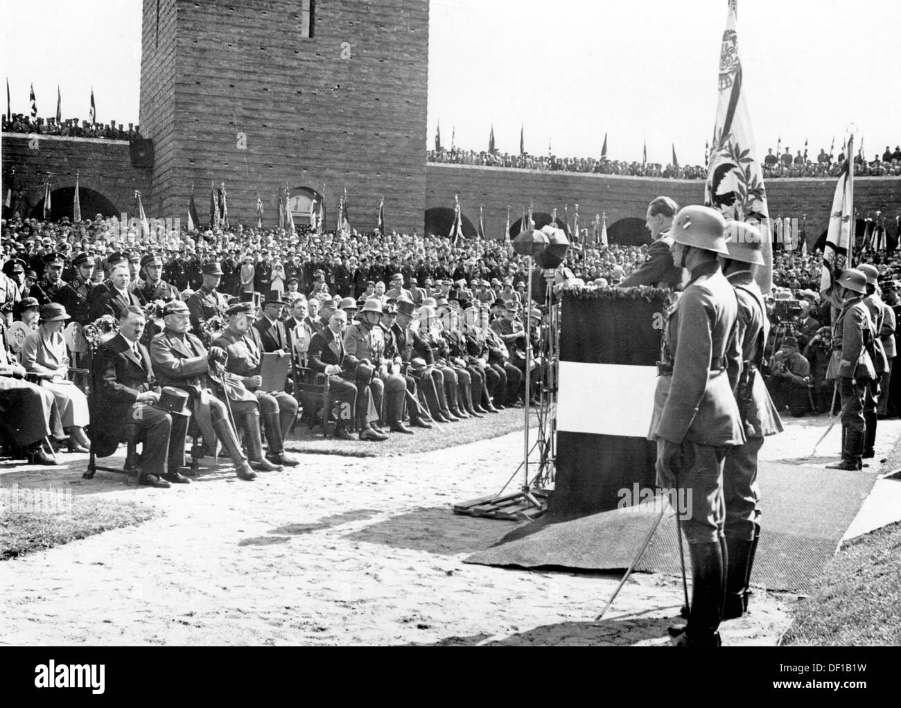 The image from the Nazi Propaganda! shows Reich Chancellor Adolf HItler during the commemoration at Tannenberg Memorial on 27 August 1933. The speech is delivered by the NSDAP Gauleiter of East Prussia, Erich Koch. In the first row (l-r): Adolf Hitler, Reich President Paul von Hindenburg, Minister President Hermann Göring, Vice Chancellor Franz von Papen, Reich Minister of War Werner von Blomberg and the leader of the Naval High Command Erich Raeder. Fotoarchiv für Zeitgeschichte Stock Photo