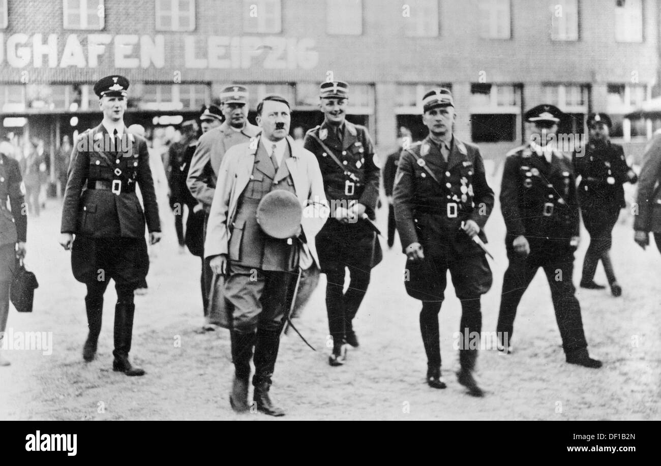 The image from the Nazi Propaganda! shows Adolf Hitler upon his arrival at the airport in Leipzig-Mockau, date unknown. (l-r): Airport manager Reinsberg, SA-Obergruppenführer Wilhelm Brückner (Chief executive officer of Hitler), SA-Oberführer Dietze (Manager of the Office for Transportation) and SA-Gruppenführer Ludwig Fichte (Head of the Measurement Office). Fotoarchiv für Zeitgeschichte Stock Photo