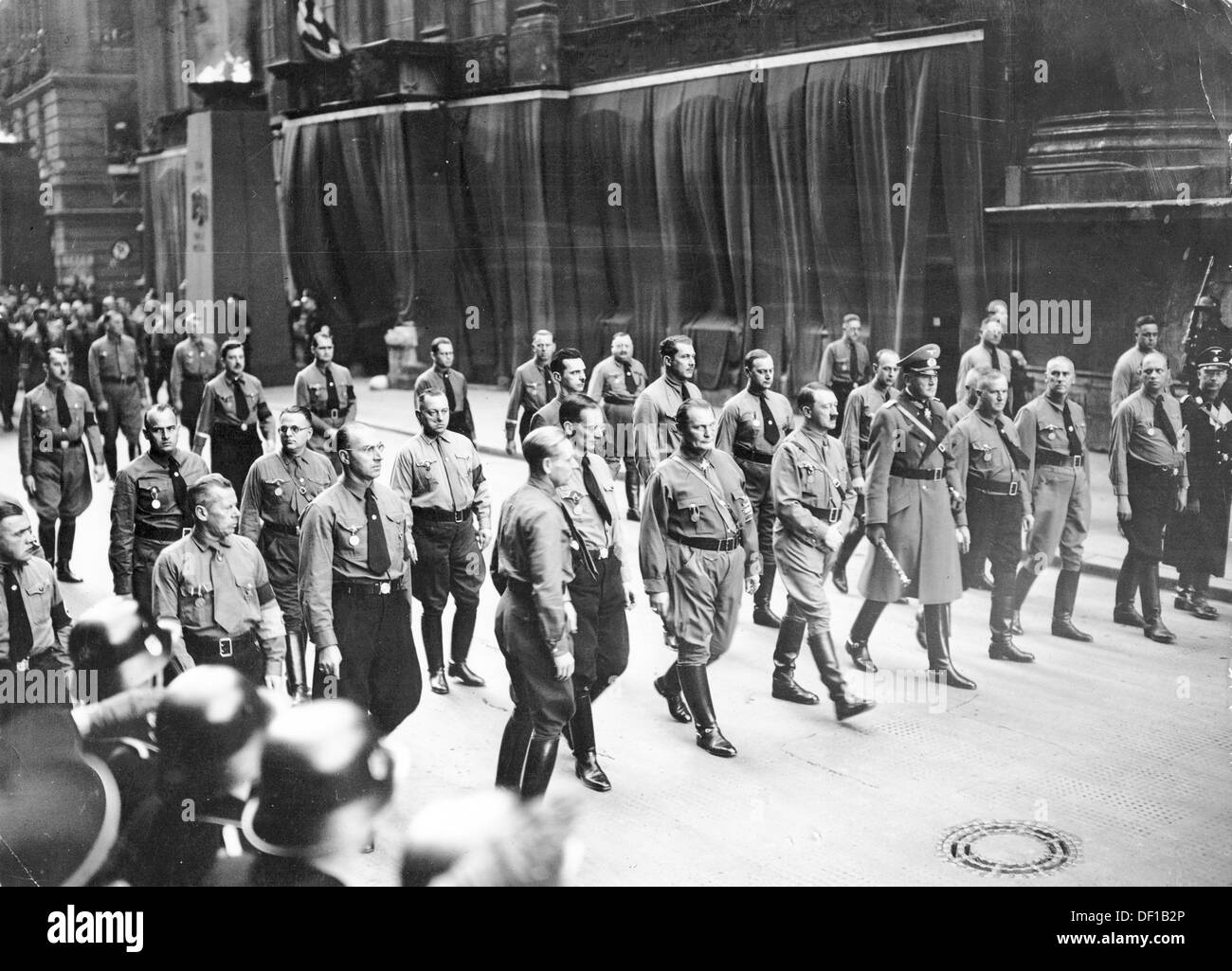 The image from the Nazi Propaganda! shows Adolf Hitler leading his supporters through Munich on a historic march on the occasion of the commemoration of the Beer Hall Putsch of 9 November 1923, on 9 November (year unknown). To Hitler's left: Hermann Göring, to Hitler's right, Minister of War Werner von Blomberg. To the very left Reichsführer SS Heinrich Himmler. Fotoarchiv für Zeitgeschichte Stock Photo