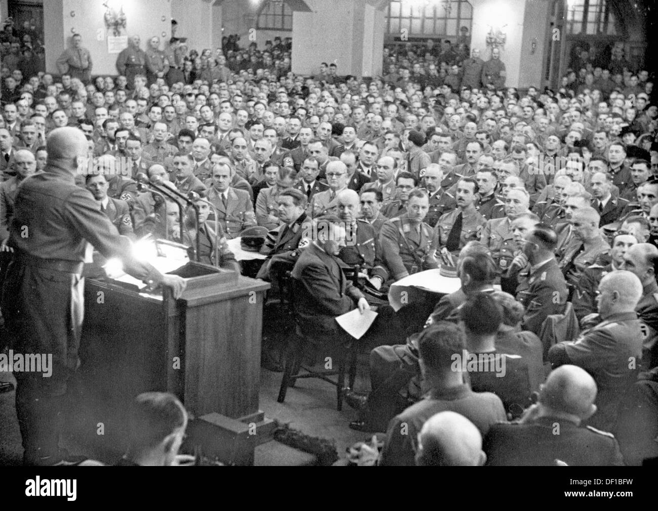 The image from the Nazi Propaganda! shows Adolf Hitler among his 'old comrades' during an hour of commemoration on the occasion of the anniversary of the Beer Hall Putsch of 9 November 1923 in Löwenbräukeller in Munich, Germany, on 9 November 1941. People: at the desk Gauleiter Adolf Wagner. Fotoarchiv für Zeitgeschichte Stock Photo