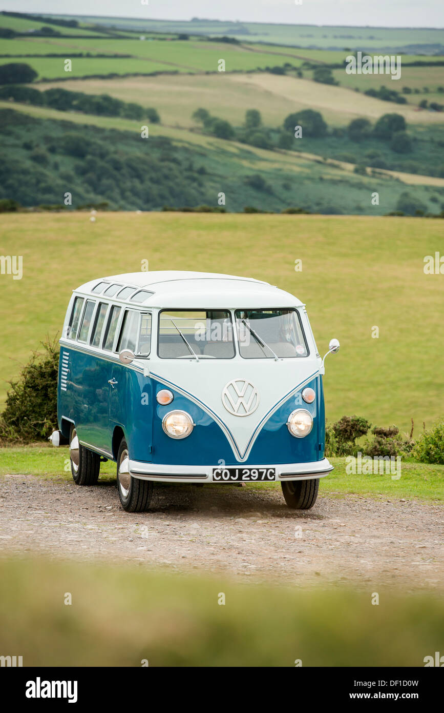 a classic VW 1965 original British RHD 21 window caravette campervan pictured in the countryside, Devon, UK Stock Photo