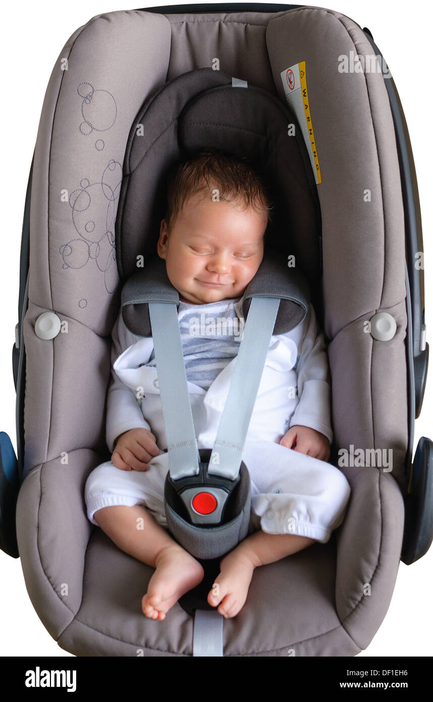 Newborn boy is sleeping and smiling in a car seat Stock Photo Alamy