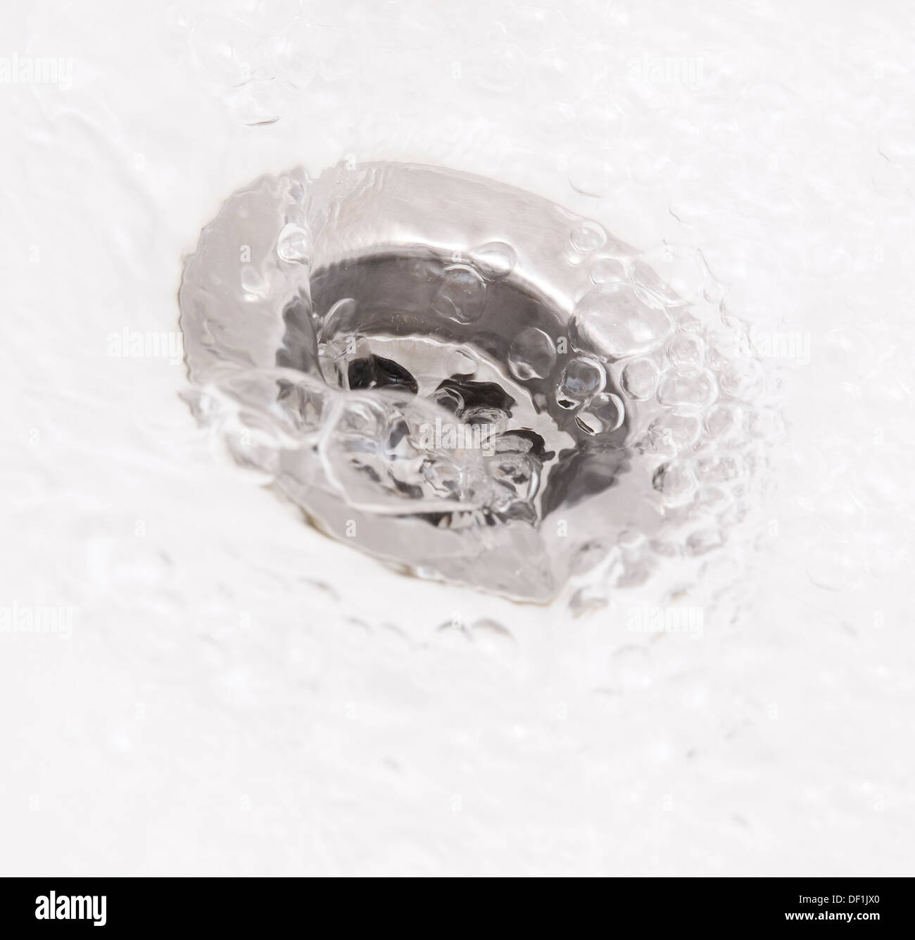 Plughole with water in square composition Stock Photo