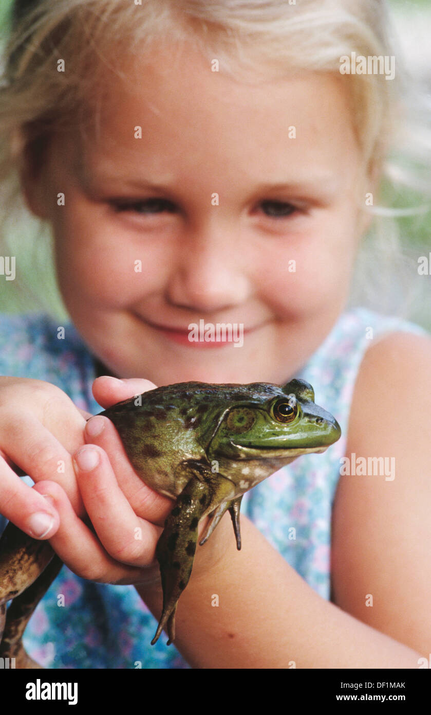 Little girl holding frog Stock Photo Alamy