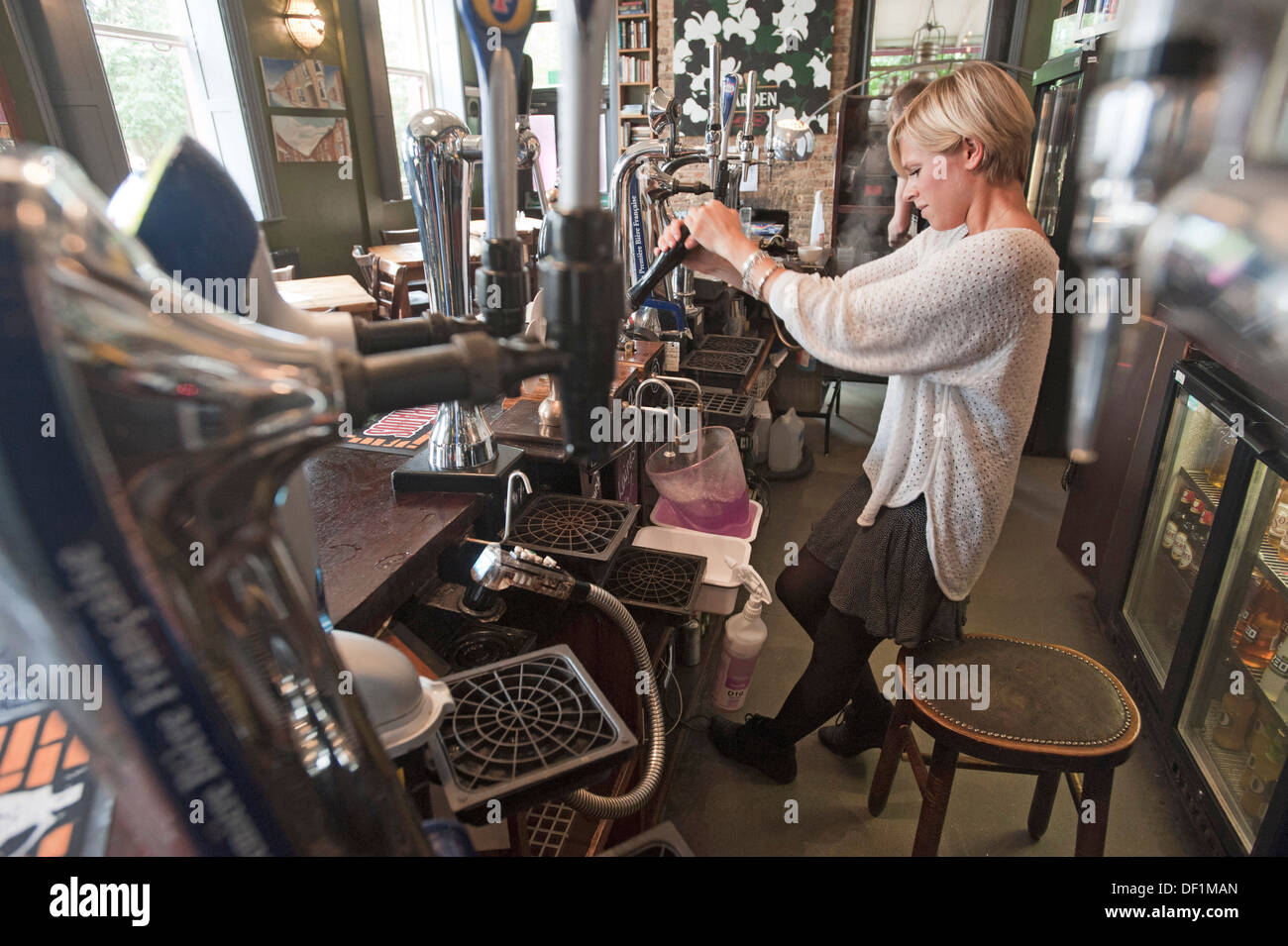 A barmaid cleaning the pipes to a new cask of beer in a pub in Brighton, England Stock Photo Alamy