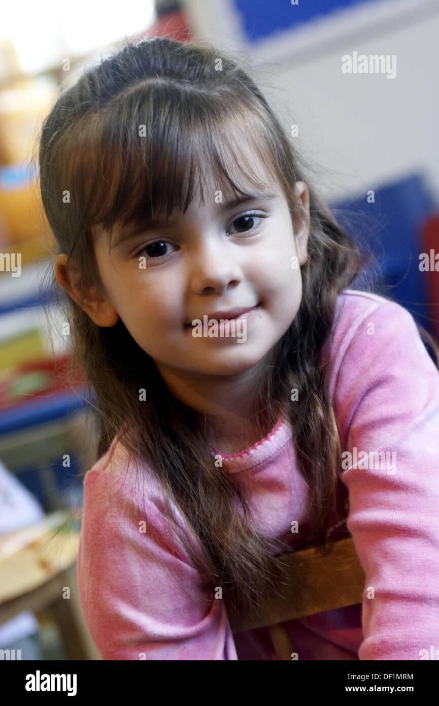 4-year-old-girl-smiling-into-camera-at-nursery-stock-photo-alamy