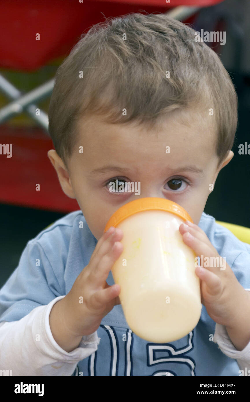 https://c8.alamy.com/comp/DF1MX7/3-year-old-boy-looking-into-camera-at-nursery-drinking-a-bottle-of-DF1MX7.jpg