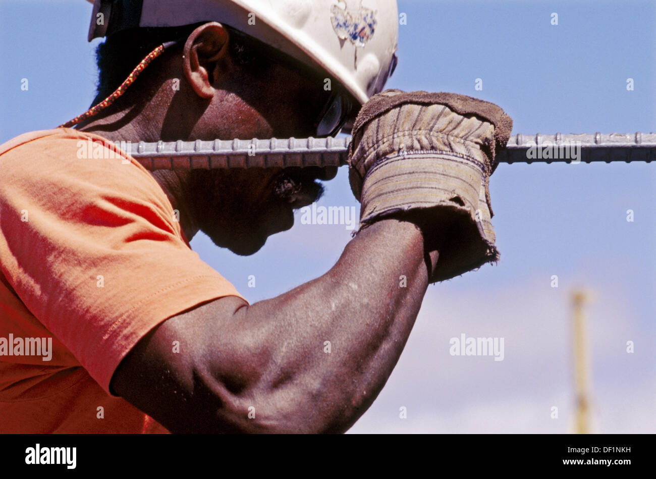 Ironworker carrying long rebar. I880 Cypress project. Oaklnad