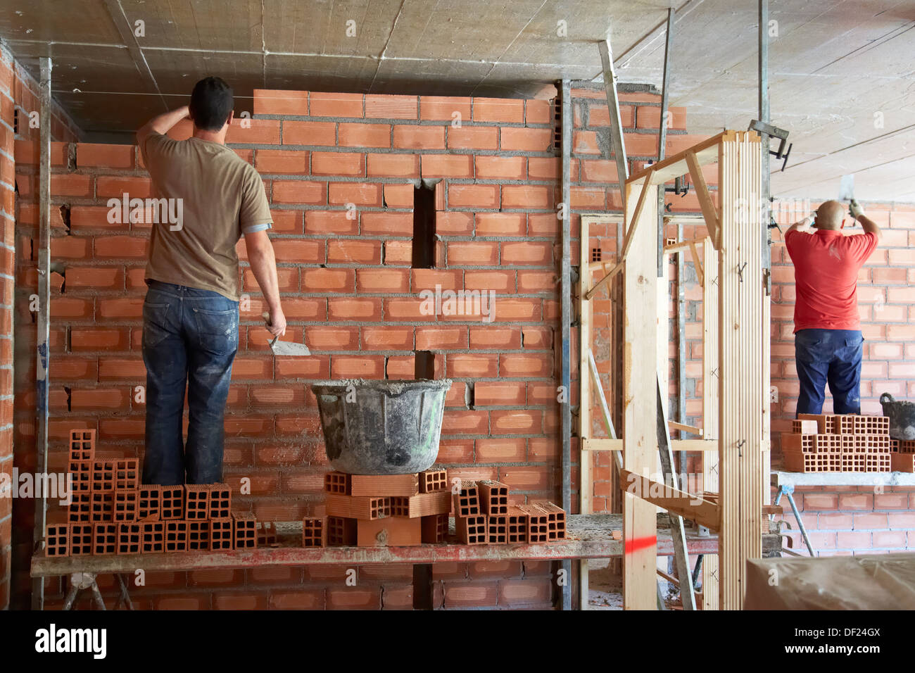 Construction worker with trowel, hand tools, Placement of brick with