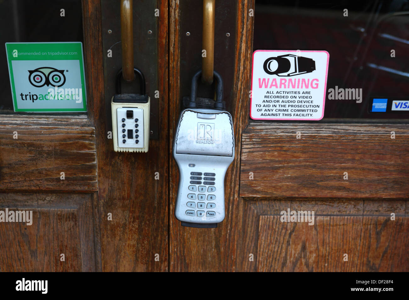 Combination padlocks and recommended by tripadvisor sticker on restaurant door, Baltimore, Maryland, USA Stock Photo