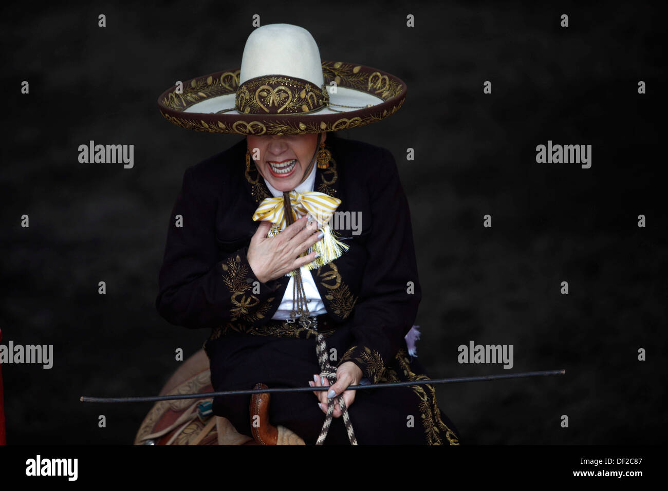 A female amazon rider smiles during an escaramuza fair at the National ...