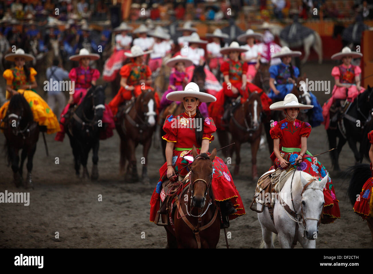 Female amazon riders ride their horses during an escaramuza fair at the ...