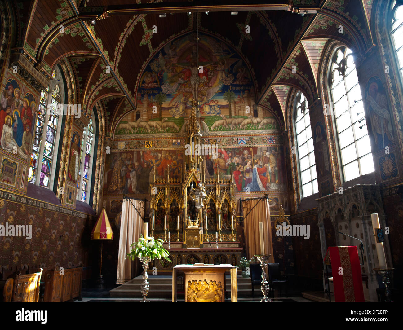 Heilig Bloed Basilick (Holy Blood Basilica) interior view of the altar with fresco and stained glass windows Stock Photo