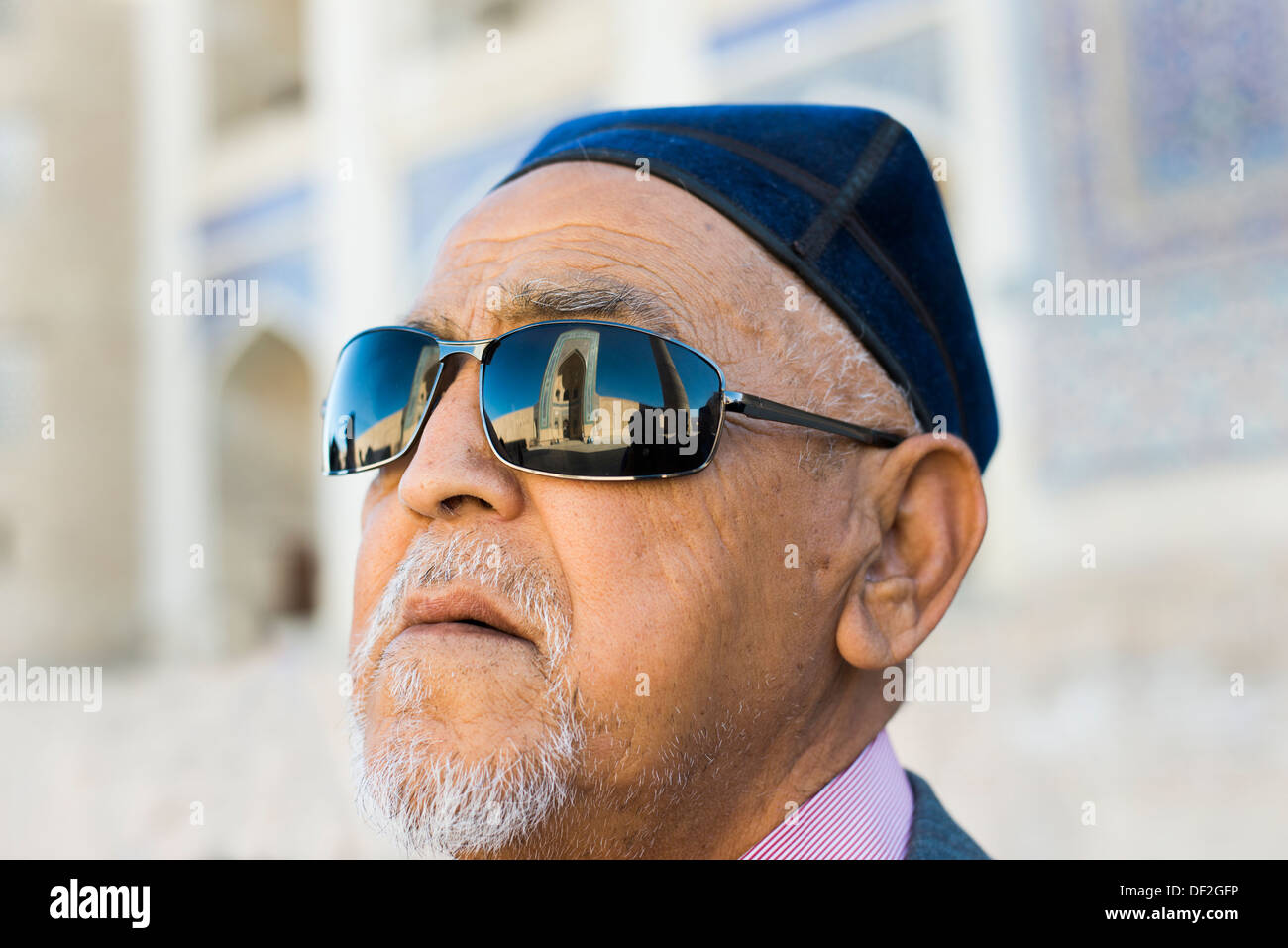 Admiring the architecture. A Tajik man looking at one of Bukhara's beautiful Madrassas. Stock Photo