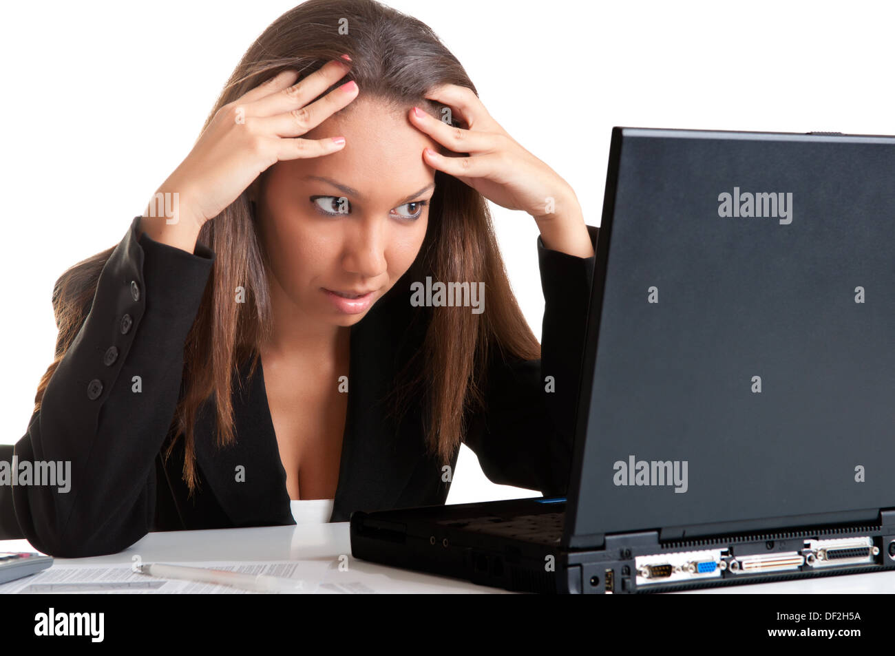 Worried businesswoman looking at a computer screen, isolated in white Stock Photo