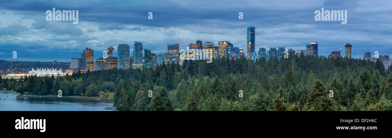 Vancouver BC Canada Downtown Skyline with Stanley Park at Evening Blue Hour Panorama Stock Photo