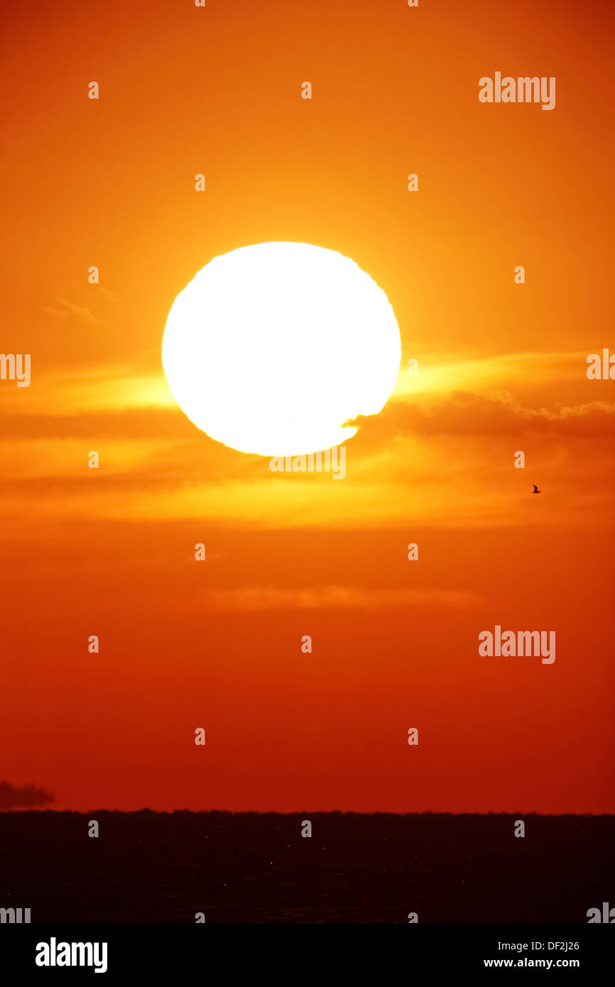 Bright big sun on the sky with clouds Stock Photo