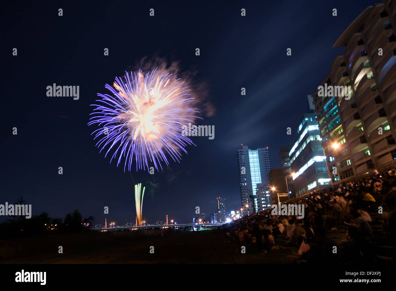 Crowd Of People Looking At Fireworks In Sky Stock Photo