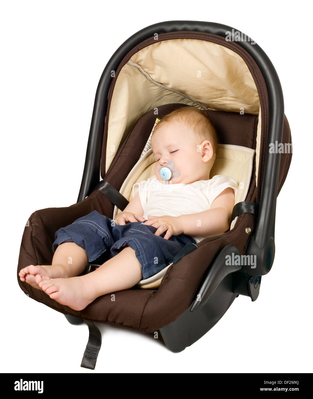 Baby boy is sitting in safety car seat Stock Photo