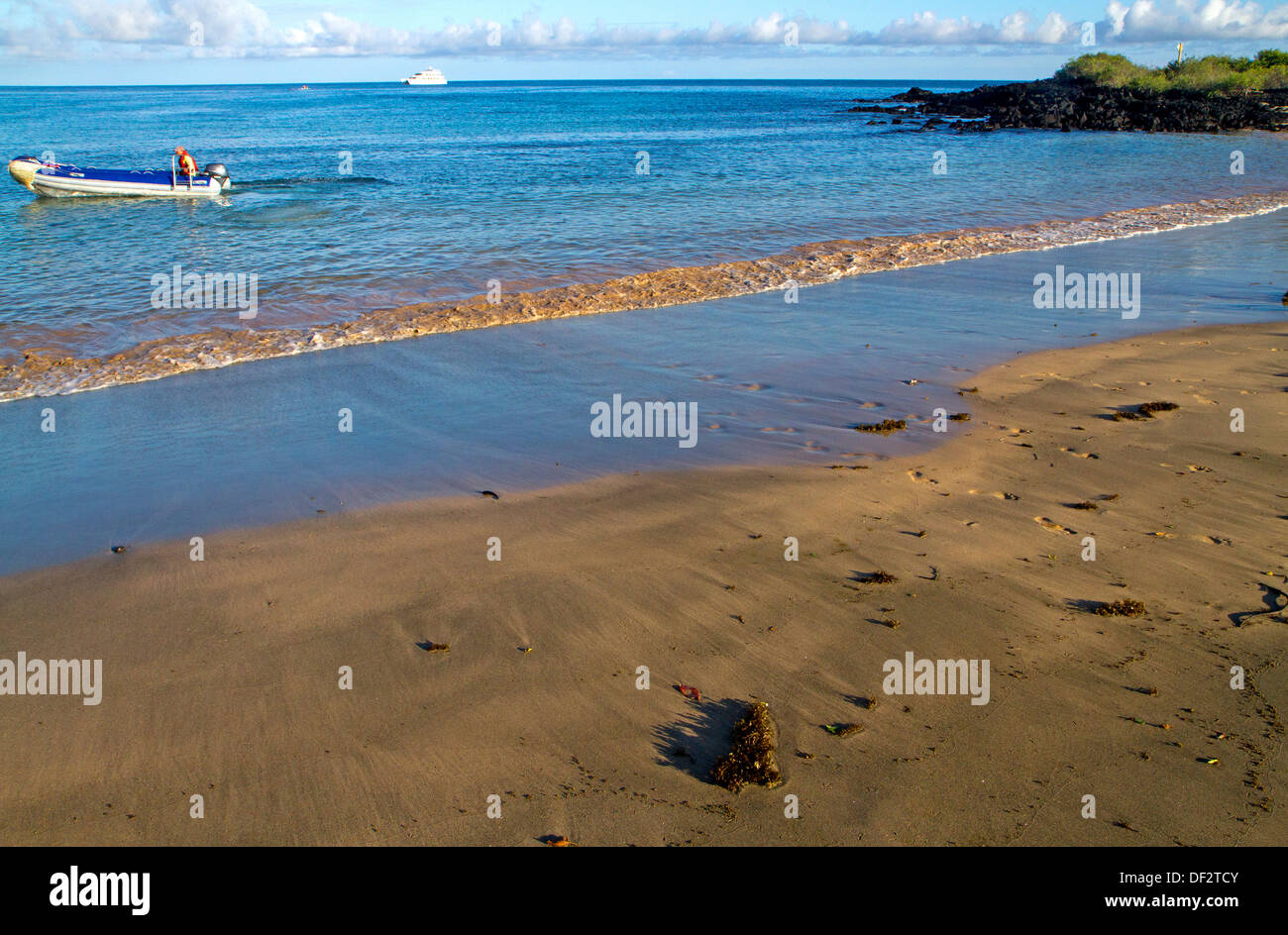 Tourist boat and zodiac at Post Office Bay, Floreana Island Stock Photo