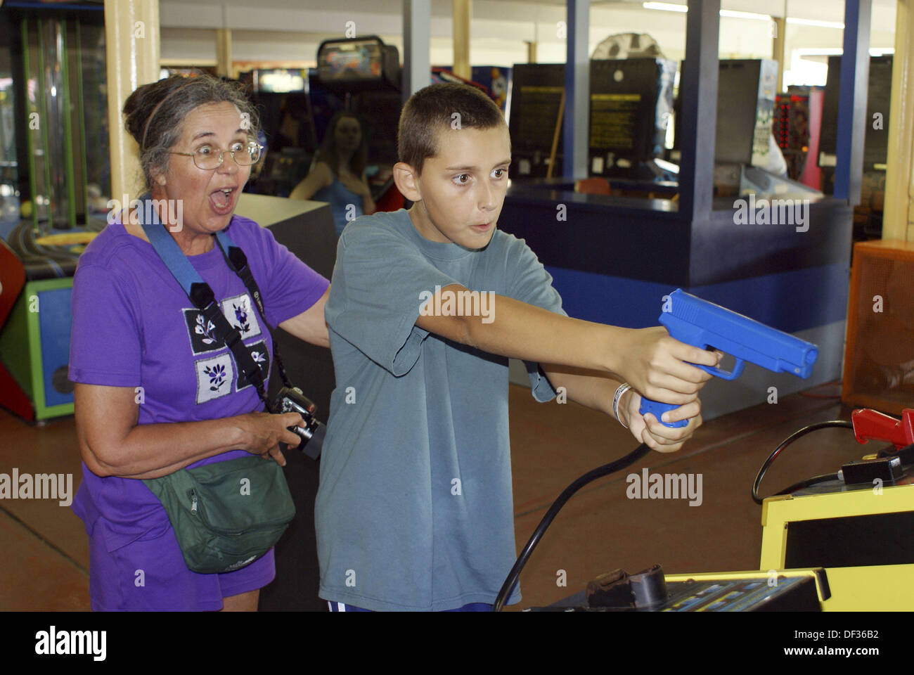 Woman excited by grandson´s accuracy at a game in an arcade. Stock Photo