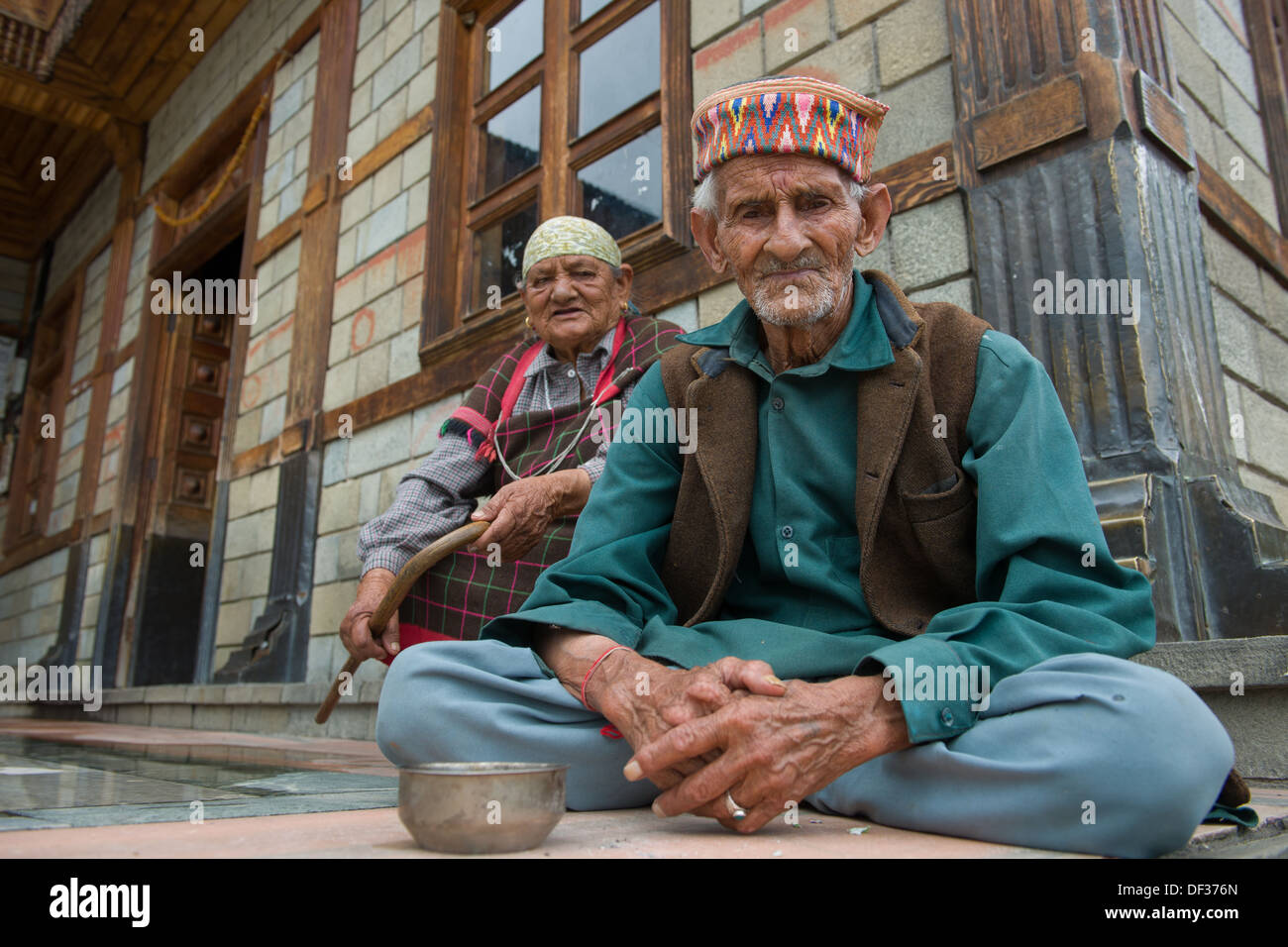 Elderly couple sitting in front of the Manu Temple, Old Manali, Manali, Himachal Pradesh, India Stock Photo