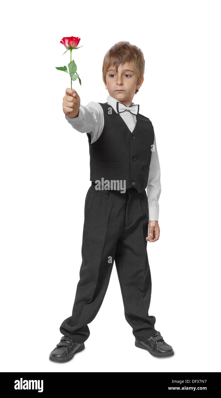 Boy in a tuxedo with a rose in hand. Isolate on white background Stock Photo