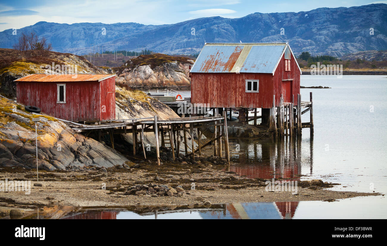 Coastal Norwegian red wooden barn and houses with piles Stock Photo