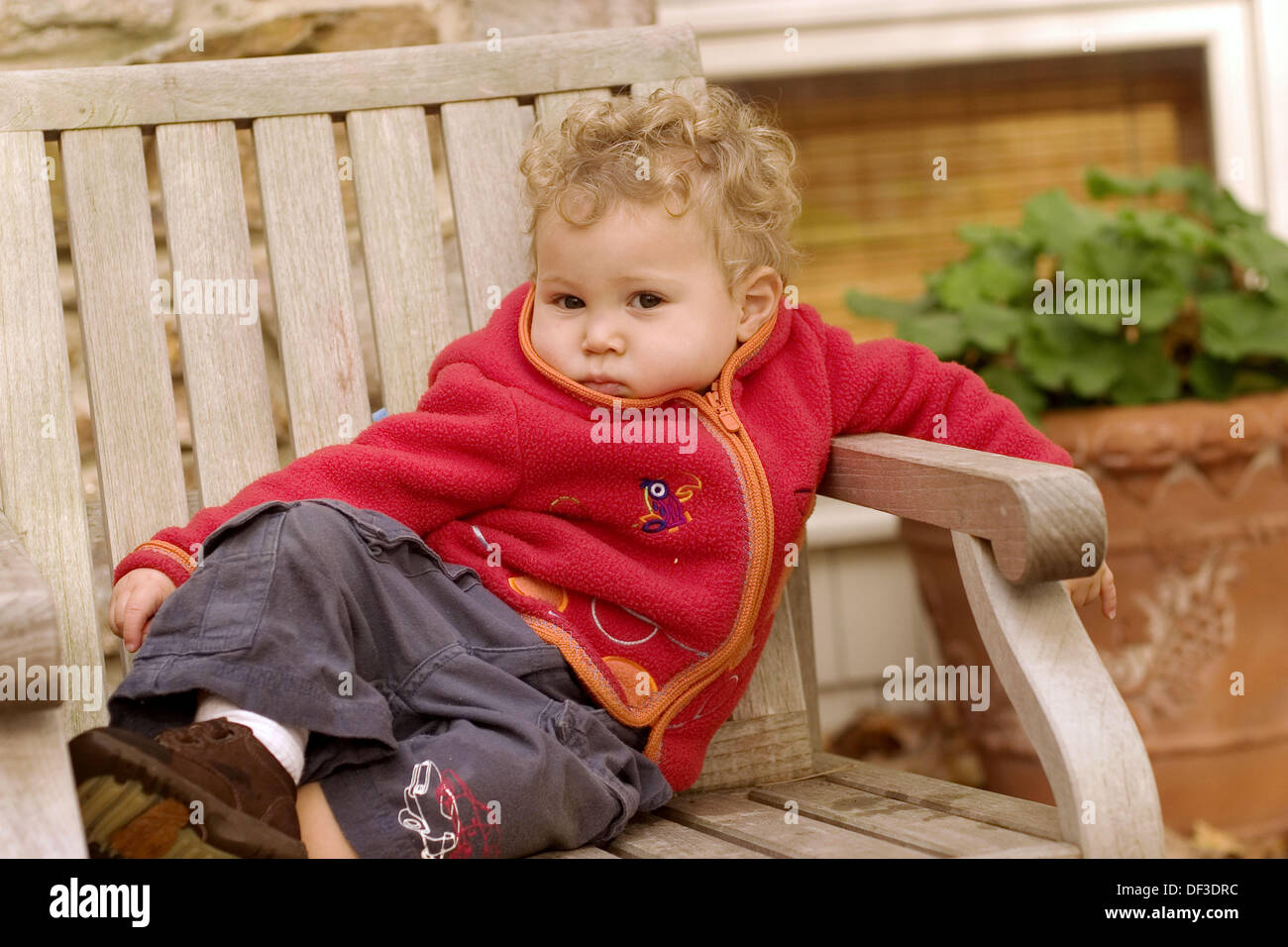 One year old boy sitting on a deck chair Stock Photo Alamy