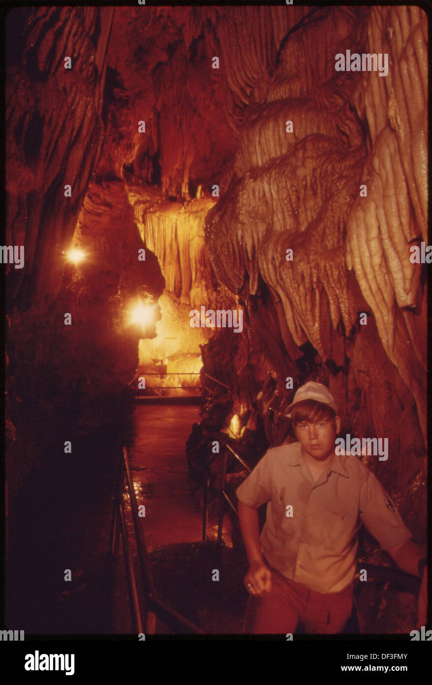 BILL MOULDER, GUIDE, NEAR THE END OF THE TOURISTS' PASSAGE IN BRIDAL CAVE. THE STALACTITES IN THE CAVE SUGGEST A... 551359 Stock Photo